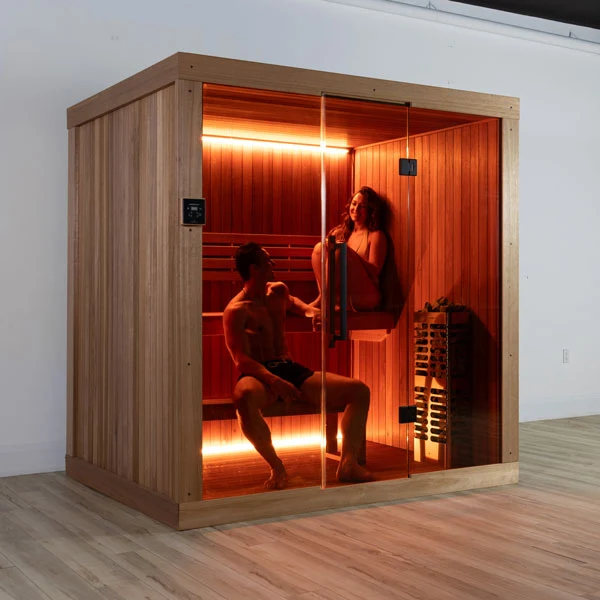 Couple relaxing inside a glass-front Recosauna Finnish sauna cabin