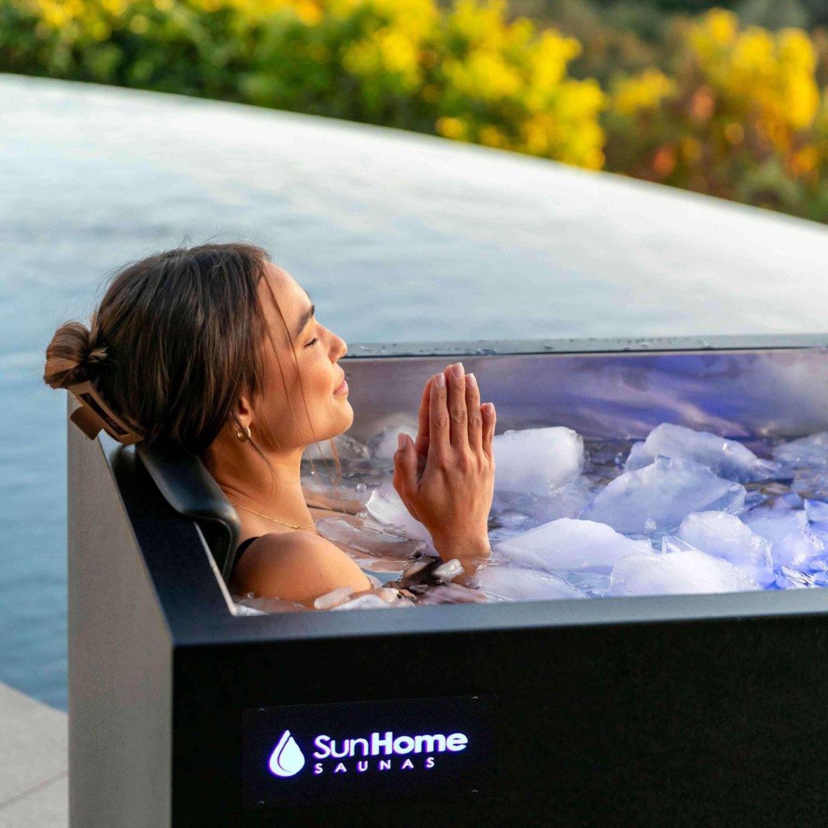 Woman relaxing in a Sun Home cold plunge tub filled with ice