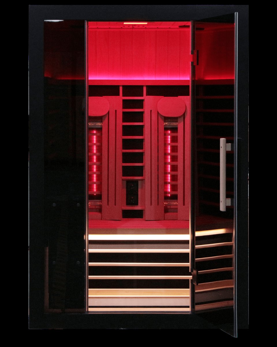 Sun Home Eclipse 2 infrared sauna with its integrated red light therapy glowing inside the cabin